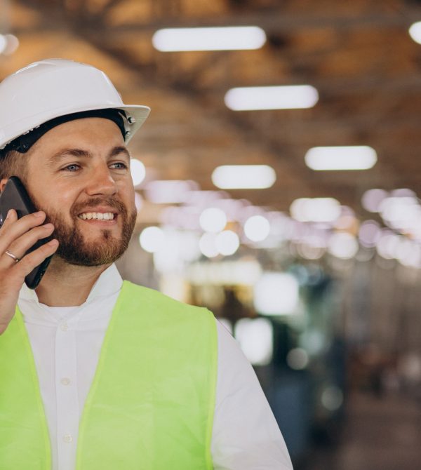 Young man engineer working on factory making order on the phone